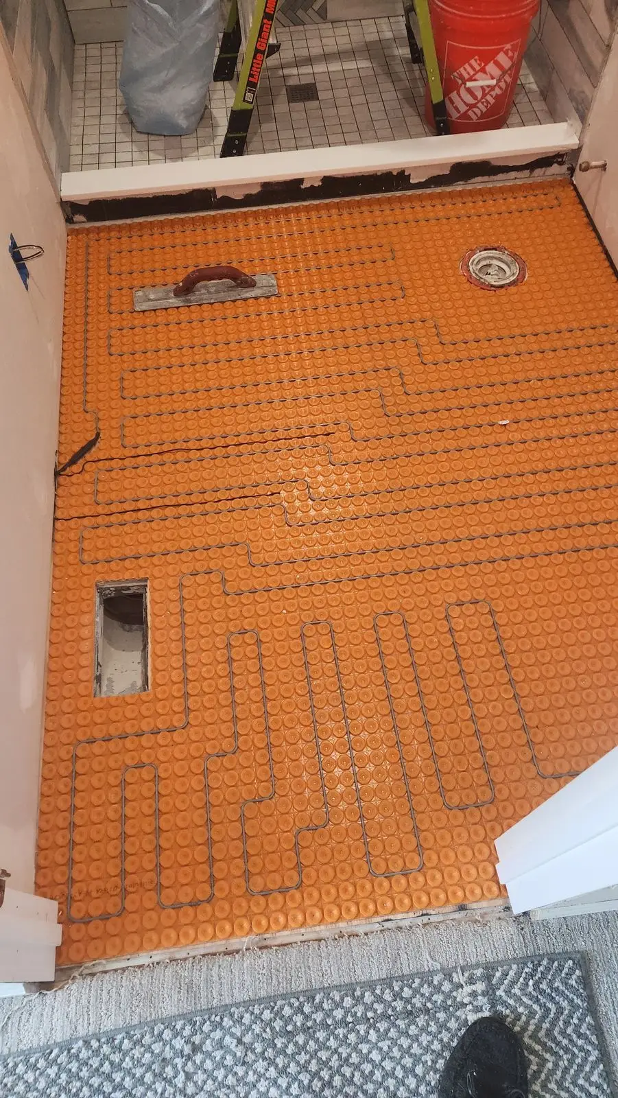 Bathroom floor heating mat laid before tile